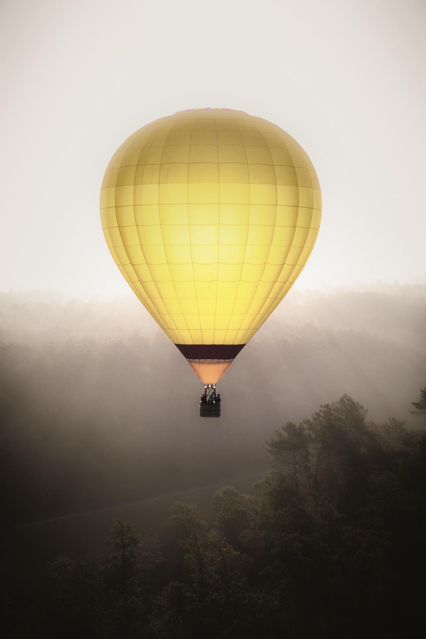 Golden Hot Air Balloon in Misty Forest