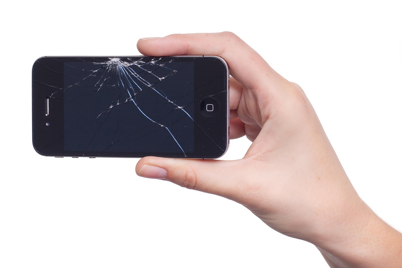 Hand Holding Phone with Broken Display