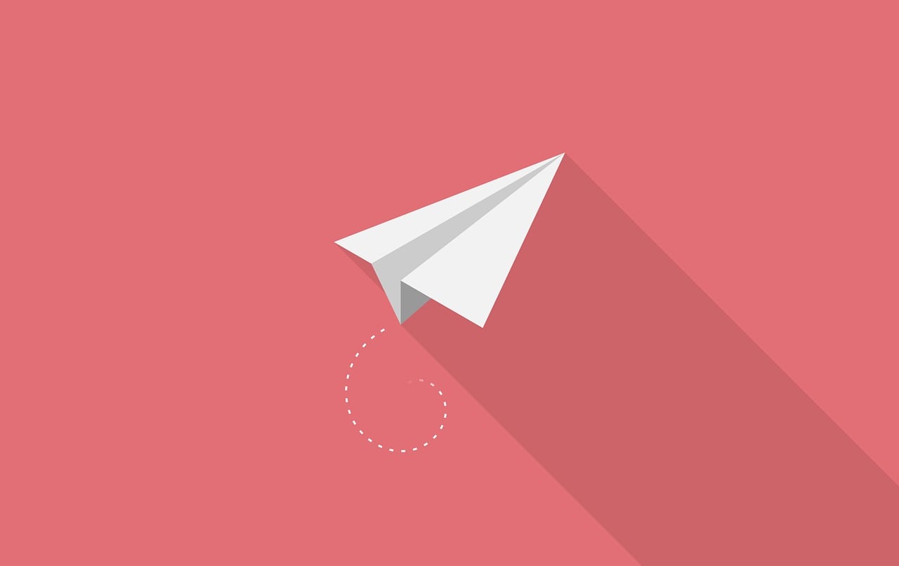 Minimal Paper Plane on Coral Background