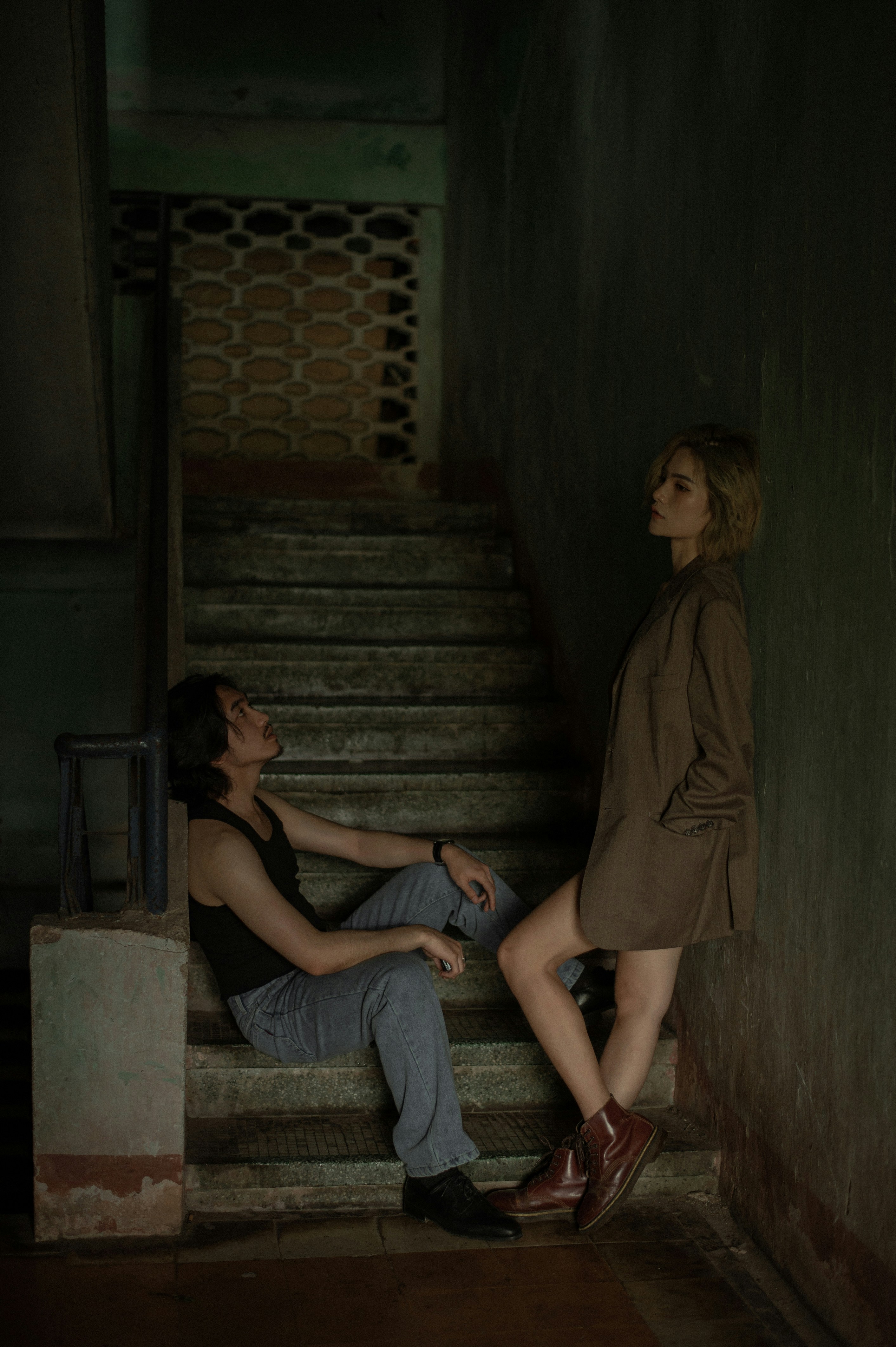 Moody Couple on Shadowy Stairway