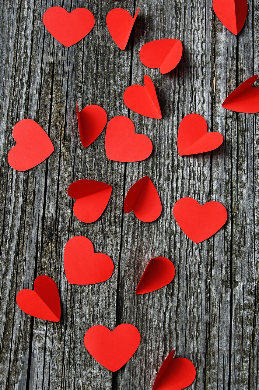 Red Paper Hearts on Weathered Wood