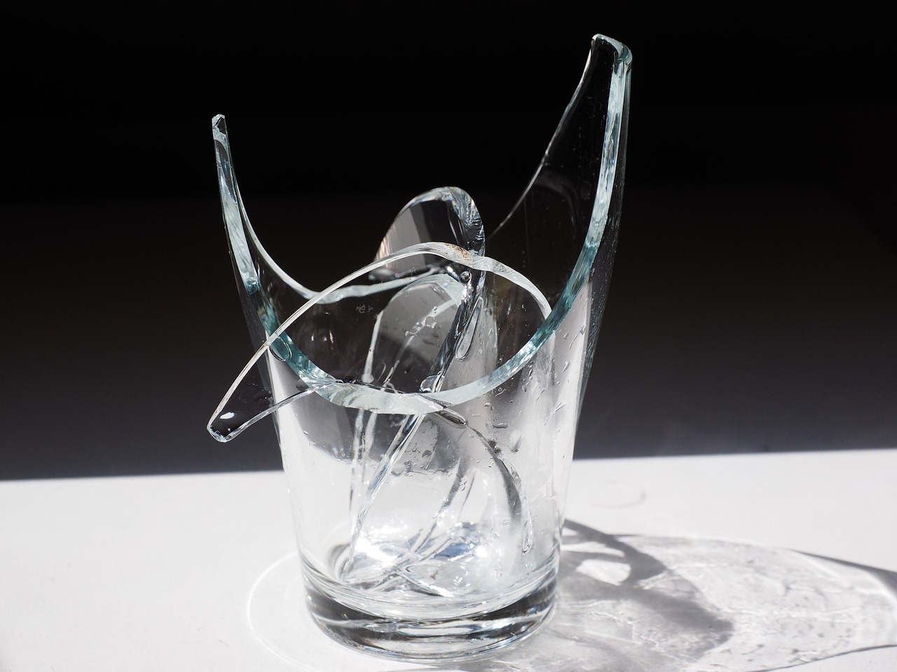 Shattered Glass Cup on Dark Background