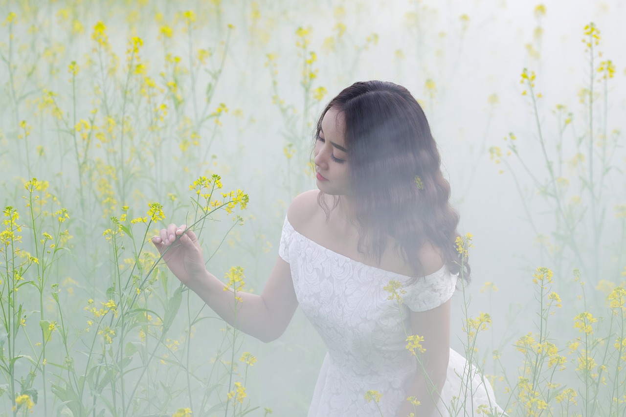 Woman in Misty Yellow Flower Field
